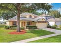 Lovely single-Gathering home boasts a lush front lawn and a convenient two-car garage at 3842 Beacon Ridge Way, Clermont, FL 34711
