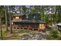 Charming cabin nestled in a wooded area, complete with a screened porch and a peaceful setting at 41513 Aspen St, Eustis, FL 32736