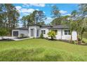 Inviting curb appeal with a well-maintained lawn, complemented by the home's contemporary exterior and landscaping at 42191 Cashew St, Eustis, FL 32736