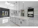 Bright, open kitchen features a large island, modern lighting, and black accent wall at 42191 Cashew St, Eustis, FL 32736