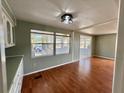 Open-concept living room features wood floors, natural light, and neutral paint at 519 Hawthorne Blvd, Leesburg, FL 34748