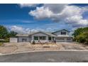 View of the home's facade, showing the landscaping and a large driveway at 5339 Kings Ct, Fruitland Park, FL 34731
