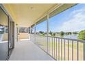 Relax on the screened patio, enjoying views of the serene lake and fountain, perfect for outdoor living at 5492 Compass Pt, Oxford, FL 34484