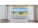 Bright, spacious room showcases sliding glass doors and a scenic view of the lake and landscape at 5492 Compass Pt, Oxford, FL 34484