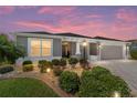 Beautiful home at dusk featuring a landscaped yard and inviting curb appeal at 560 Caputo Ct, The Villages, FL 32163
