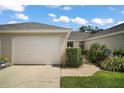 A well-maintained home with a one-car garage, manicured landscaping, and a clean driveway at 579 Juniper Way, Tavares, FL 32778