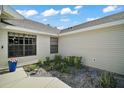 Side view of home showing the stone garden at 579 Juniper Way, Tavares, FL 32778