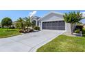 Close up of a spacious driveway with decorative inlays leading to an attached garage at 5818 Greenbriar Loop, Leesburg, FL 34788