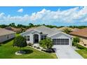 Beautiful single story home with well-manicured landscaping and a spacious driveway at 5818 Greenbriar Loop, Leesburg, FL 34788