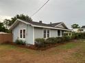 Charming single story home with light blue siding and well-manicured landscaping around the front at 604 N Old Wire Rd, Wildwood, FL 34785