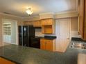 Functional kitchen with ample counter space, cabinetry, and black appliances at 619 W Seminole Ave, Eustis, FL 32726