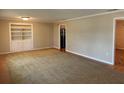 Living room showcasing neutral walls, built-in shelving and access to other rooms at 619 W Seminole Ave, Eustis, FL 32726