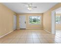 Bright living room with tiled flooring, ceiling fan, and a window with a view at 6808 Fern Cir, Leesburg, FL 34748
