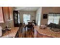 Cozy dining area with wood flooring, natural light, and adjacent to kitchen and living area at 704 Chelsea Ave, Fruitland Park, FL 34731