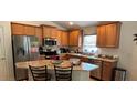 Well-equipped kitchen featuring stainless steel appliances, granite countertops, and ample cabinet space at 704 Chelsea Ave, Fruitland Park, FL 34731