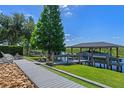 Scenic waterfront property with a private boat dock featuring a covered boat lift and a charming walkway at 722 Barefoot Bay Loop, Groveland, FL 34736