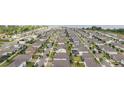 Expansive aerial view capturing a well-planned residential area with tree-lined streets and manicured lawns near a lake at 743 Brooks Field Drive Dr, Winter Garden, FL 34787