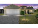 Charming single-story home with a well-maintained lawn, an attached garage, and a cozy screened-in porch at 923 Oleander St, The Villages, FL 32159