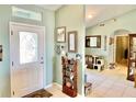 Inviting entryway with decorative door, tile flooring, and wall decorations, leading into the home's welcoming interior at 974 Forest Hill Dr, Minneola, FL 34715