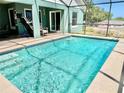Screened-in pool features crystal-clear water and a spacious deck, creating a perfect outdoor oasis for relaxation and entertainment at 974 Forest Hill Dr, Minneola, FL 34715
