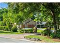 An inviting home with stone accents, lush greenery, and a charming mailbox in a serene neighborhood at 111 Kentucky Blue Cir, Apopka, FL 32712