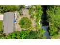 Aerial view of the home with a large backyard and access to a canal at 11114 Lake Eustis Dr, Leesburg, FL 34788