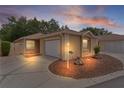 Charming single-story home with a manicured lawn and a two-car garage during dusk at 1121 Ricardo Ave, The Villages, FL 32159