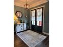Elegant entryway with a decorative rug, modern lighting, and stylish decor at 121 N Summit Ave, Lake Helen, FL 32744