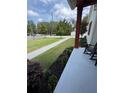 Inviting covered porch with rocking chairs and a view of the landscaped front yard at 121 N Summit Ave, Lake Helen, FL 32744