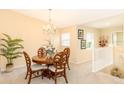 Bright dining room featuring a round wood table, four chairs, and an elegant chandelier at 1288 Grady Ln, Davenport, FL 33896