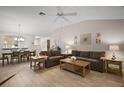 Bright living room featuring wood floors, a ceiling fan, and stylish furniture at 1318 Guerra Ave, The Villages, FL 32159