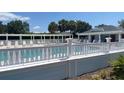 Community pool area featuring ample seating and a well-maintained pool deck at 1404 Georgiana Ter, The Villages, FL 32162