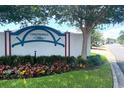 Chesterfield Villas community sign with colorful flowers and lush greenery at 1404 Georgiana Ter, The Villages, FL 32162