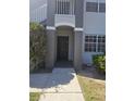 Front door with neutral paint and white trim, set against a backdrop of lush landscaping and shade at 14049 Fairway Island Dr # 118, Orlando, FL 32837