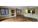 Spacious living room with tile flooring, open layout, and adjacent kitchen featuring dark wood cabinets at 14049 Fairway Island Dr # 118, Orlando, FL 32837