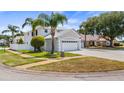 Well-maintained corner lot home with a two-car garage and lush landscaping in a tranquil neighborhood at 16608 W Citrus Pkwy, Clermont, FL 34714