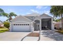 Beautiful home exterior featuring a two-car garage, attached carport, and manicured landscaping at 16608 W Citrus Pkwy, Clermont, FL 34714