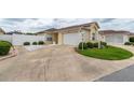 Home exterior showcasing a well-maintained driveway, lawn, and landscaping at 17174 Se 76Th Caledonia Ter, The Villages, FL 32162
