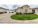 Well-manicured lawn and landscape highlight this home's exterior at 17174 Se 76Th Caledonia Ter, The Villages, FL 32162