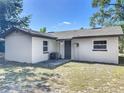 Exterior of a well-maintained home, featuring a neutral color palette and a compact backyard at 1905 Selleen Dr, Eustis, FL 32726