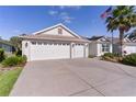 Charming single-story home featuring a three-car garage and long driveway at 2124 Hames Ln, The Villages, FL 32162
