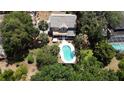 A lovely home has a backyard with a pool and mature landscaping at 26 Weston Rd, Leesburg, FL 34748