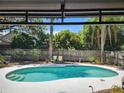 Inviting backyard pool has a serene outdoor escape, complete with lush greenery and shade trees at 26 Weston Rd, Leesburg, FL 34748