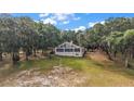 A-frame home nestled among mature trees, offering natural light through its many windows and a peaceful retreat at 27011 Se Highway 42, Umatilla, FL 32784