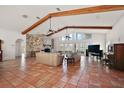 Expansive living room featuring tile flooring, vaulted ceiling, and stone fireplace at 27011 Se Highway 42, Umatilla, FL 32784