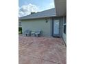 Relaxing back patio area with outdoor seating and a convenient door leading inside the residence at 2750 Coral Reef Way, Tavares, FL 32778