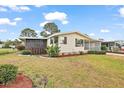 Well maintained home with a beautiful lawn, manicured bushes, and a screened-in porch at 2921 Wekiva Rd, Tavares, FL 32778