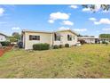 The side of the home features manicured landscaping and a well-kept lawn at 2921 Wekiva Rd, Tavares, FL 32778