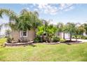 A well maintained yard, with beautiful tropical landscaping framing a cozy home at 30 Olive Cir, Ocala, FL 34472