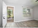 Inviting living area featuring modern flooring and a glimpse of the outdoor view at 30 Olive Cir, Ocala, FL 34472